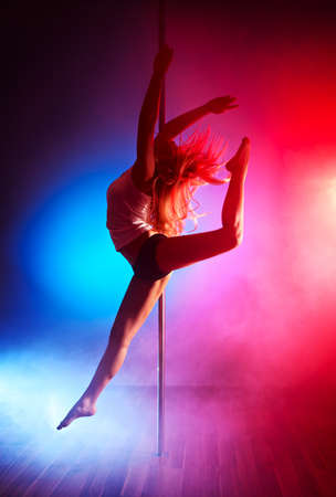 Young pole dance woman jumping.の写真素材