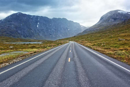 Road perspective in overcast weather. Norway landscape.