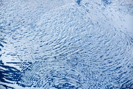 Ripple on water. Blue tint.の写真素材