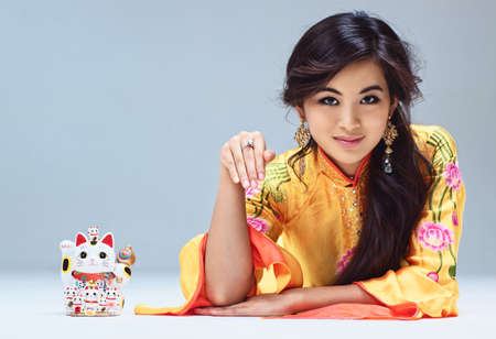 Young japanese woman with maneki neko cat 