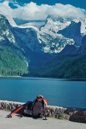 Alps mountain landscape. Hiking equipment on foreground.