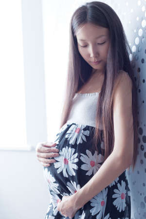 Young pregnant asian woman portrait.の写真素材