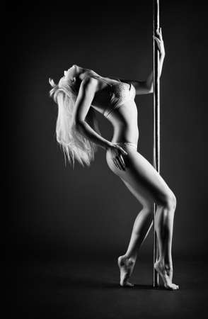 Young slim pole dance woman の写真素材