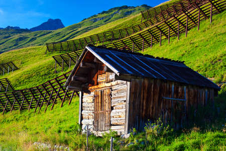 Small barn on Alps mountains background.の写真素材