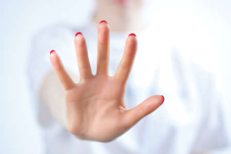 Young woman showing palm handsign の写真素材
