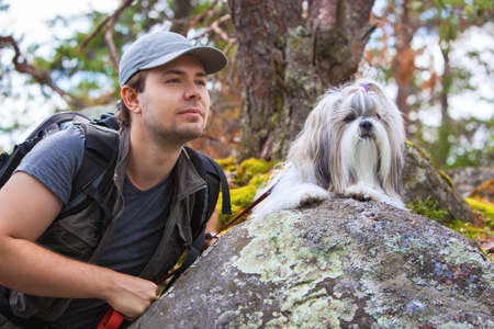 Young man tourist with shih-tzu dog portrait.の写真素材