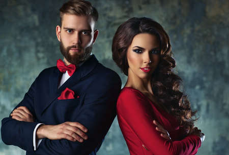 Young elegant couple in evening dress portrait. Standing shoulder to shoulder.の写真素材
