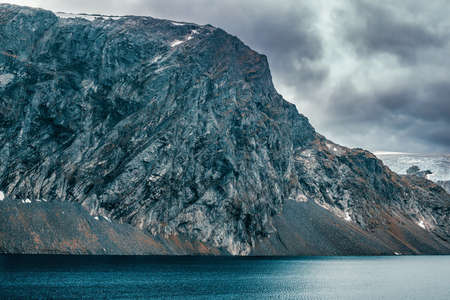 Norway high mountains cold and severe landscape. Big mountain over lake.の写真素材