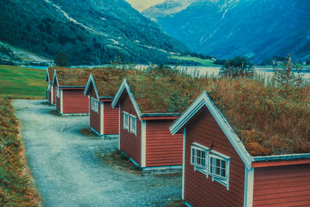 Norway mountains landscape with traditional cabins. Retro style film colors.の写真素材