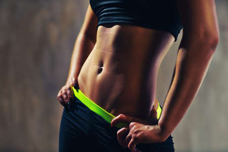 Young sports sexy woman abdominal musclesの写真素材