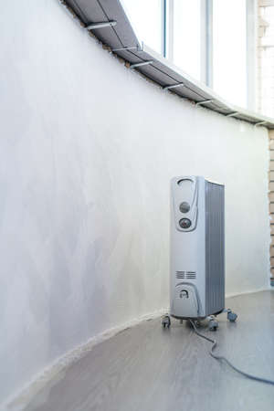 Electrical heater under windows in home with new interiorの写真素材