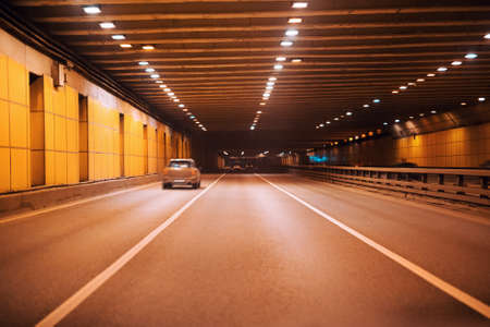 Underground modern highway tunnel with several cars