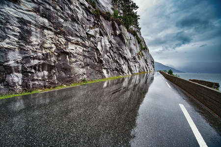 Wet road after rain in Norway. Car driving safety concept.の写真素材