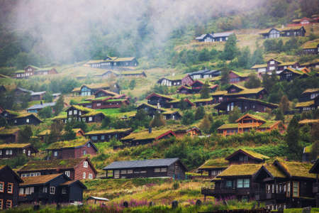 Buildings on high mountains in Norway. Overcast weather with fog.の写真素材