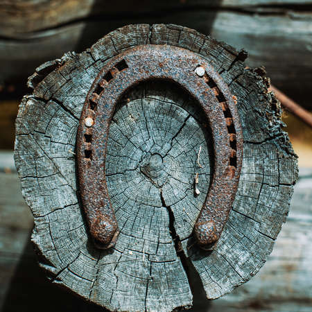 Horseshoe on house log. As a symbol of luck.の写真素材