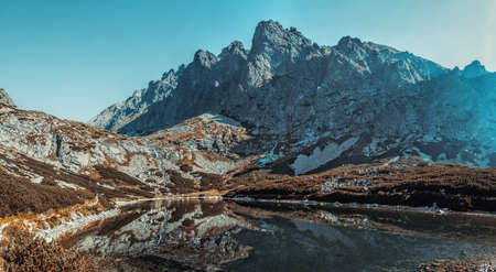 High Tatra mountains in Slovakia landscape panorama with lake. Autumn dramatic colors.の写真素材