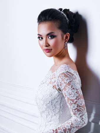 Young asian woman fashion indoors portrait on white wall backgroundの写真素材