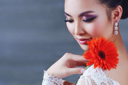 Young asian woman with flower soft colors portraitの写真素材