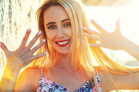 Young smiling woman sunny outdoors portraitの写真素材
