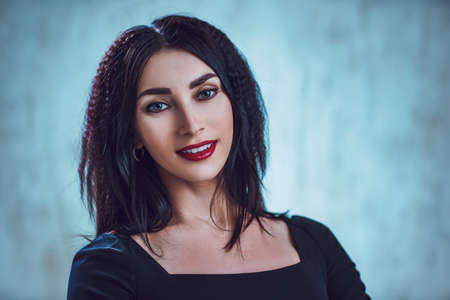 Young smiling business woman portrait on gray background