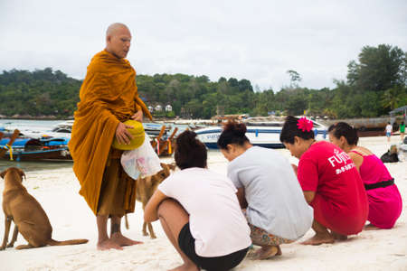 SATUN - FEBRUARY 25 Buddhist monks walk collecting alms in the morning  on FEBRUARY 25, 2013 in Koh lipe SATUN, Thailand のeditorial素材
