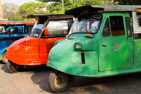 AYUTTHAYA, THAILAND - 17 MARCH  Thai Tuk Tuk taxis wait for customers near the Wat Mahathat on March 17, 2013 in AYUTTHAYA, Thailand のeditorial素材