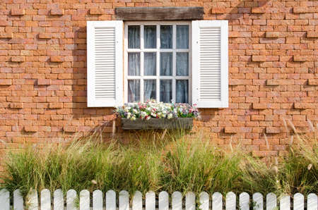Vintage white window on red brick wall