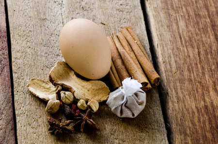 Spices lying on a wooden surface closeupの写真素材