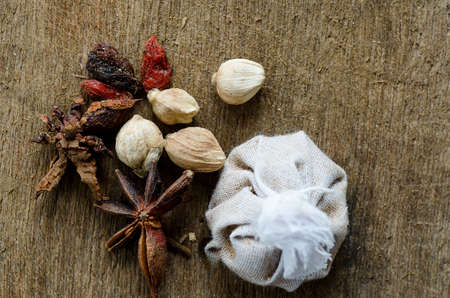 Spices lying on a wooden surface closeupの写真素材