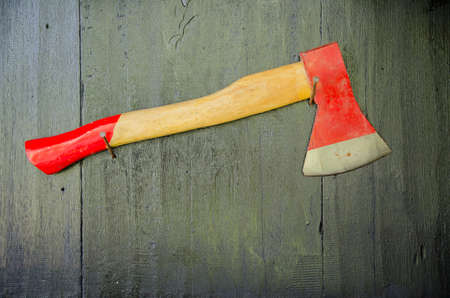 Red axe on the wood wallの写真素材