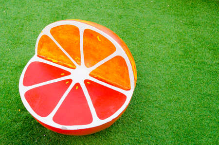 Orange chair on the lawnの写真素材