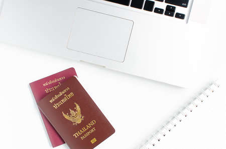 Thailand passport with laptop on white background, Find travel informationの写真素材