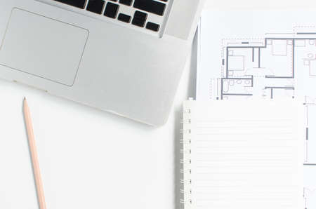 Computer and Blueprint Architecture on white deskの写真素材