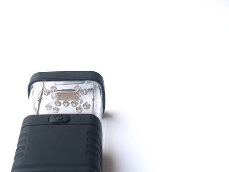 black LED flashlight or torch on white isolated backgroundの写真素材