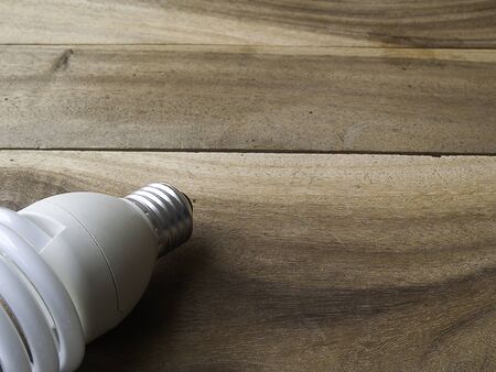 energy saving light bulb on old wooden backgroundの写真素材