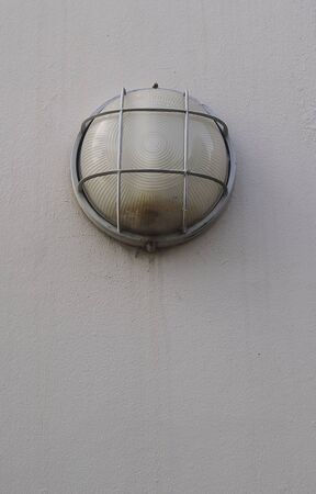 old streetlight with cement wall backgroundの写真素材