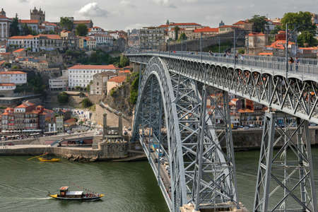 View of the historic city of Porto, Portugal with the Dom Luiz bridge.の写真素材