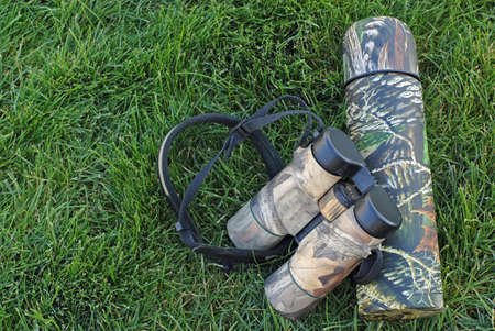 Camo Coffee and Binoculars in Green Grassの写真素材