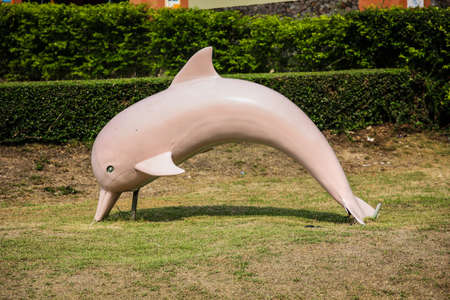 White dolphin statue in the park.の写真素材