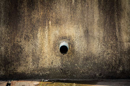 Sewage pipes and old cement の写真素材