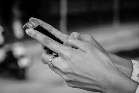 Closeup of female hand using a smart phone. Shallow depth of fieldの写真素材