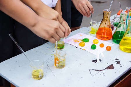 Flask in student hand with test tubeの写真素材