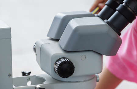 Close-up of a male student using microscopeの写真素材