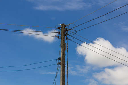 Photo of an electric pole with a many cablesの写真素材