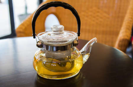 teapot on brown tableの写真素材