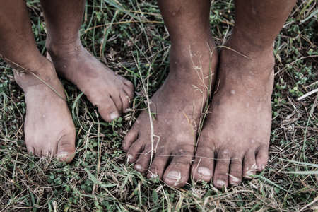 The feet of boy on the grass