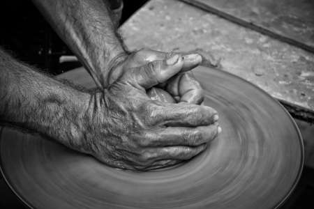 hands of a man, creating an earthen jar on the circleの写真素材
