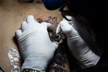 tattooer showing process of making a tattoo. Tattoo design in patternの写真素材