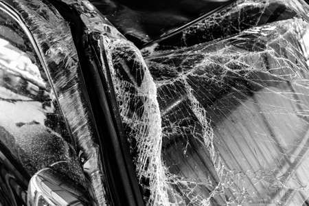 A shattered glass windscreen of a car