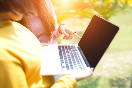 Teacher and student using laptop,smartphone during study or test at lawn. Learning outside the classroom.の写真素材